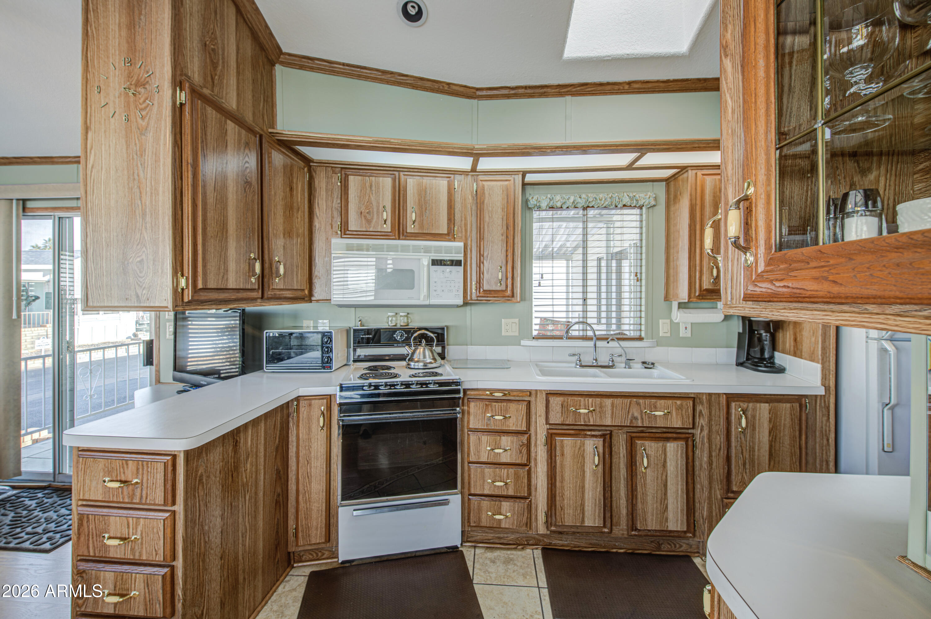 111 South Greenfield Road, Unit 765 Mesa, AZ 85206 - Photo 11 of 31 a kitchen with stainless steel appliances granite countertop a stove a sink and a refrigerator