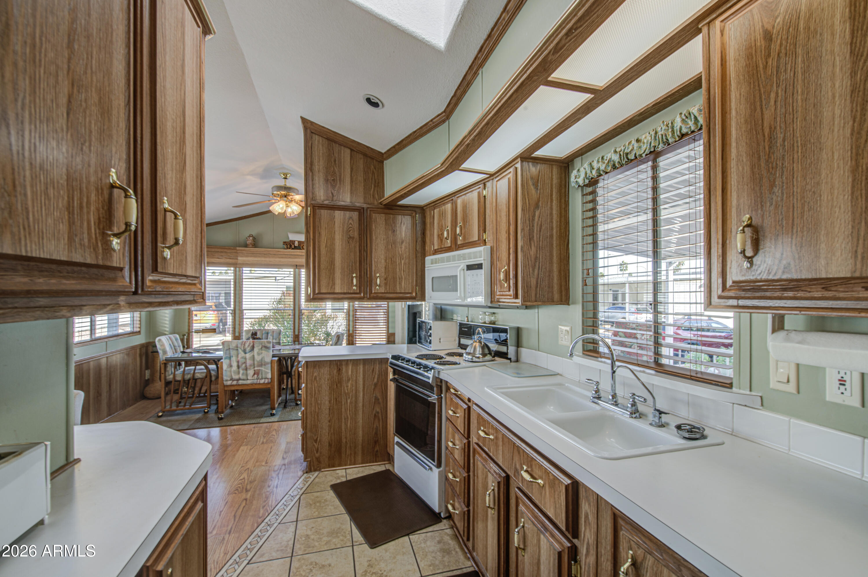 111 South Greenfield Road, Unit 765 Mesa, AZ 85206 - Photo 13 of 31 a kitchen with lots of counter top space and wooden floor