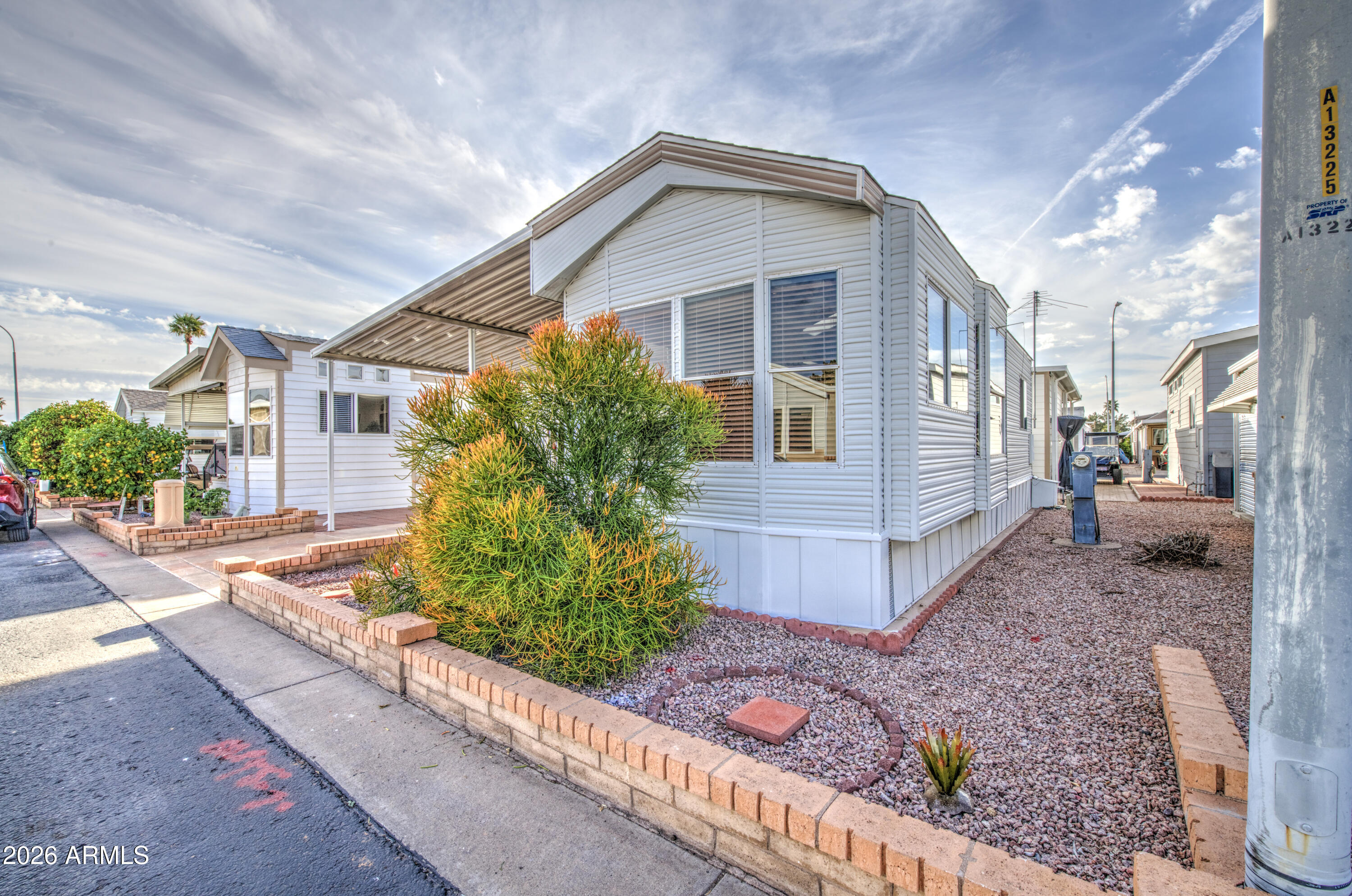 111 South Greenfield Road, Unit 765 Mesa, AZ 85206 - Photo 2 of 31 a front view of a house with garden