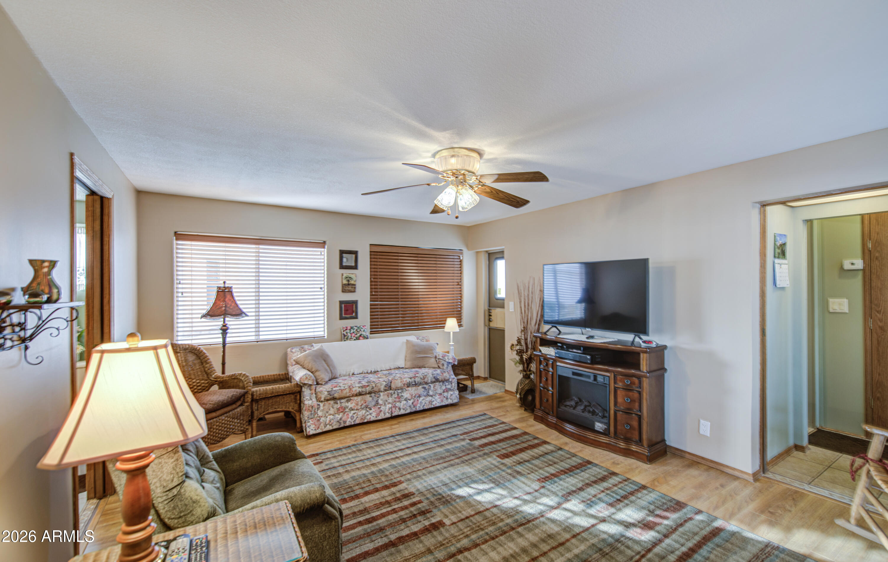 111 South Greenfield Road, Unit 765 Mesa, AZ 85206 - Photo 23 of 31 a living room with furniture and a flat screen tv