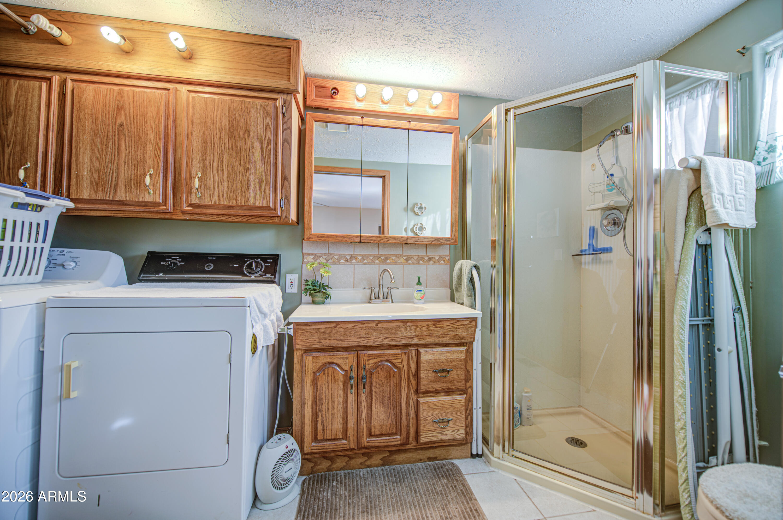 111 South Greenfield Road, Unit 765 Mesa, AZ 85206 - Photo 25 of 31 a bathroom with a granite countertop sink a mirror and a shower