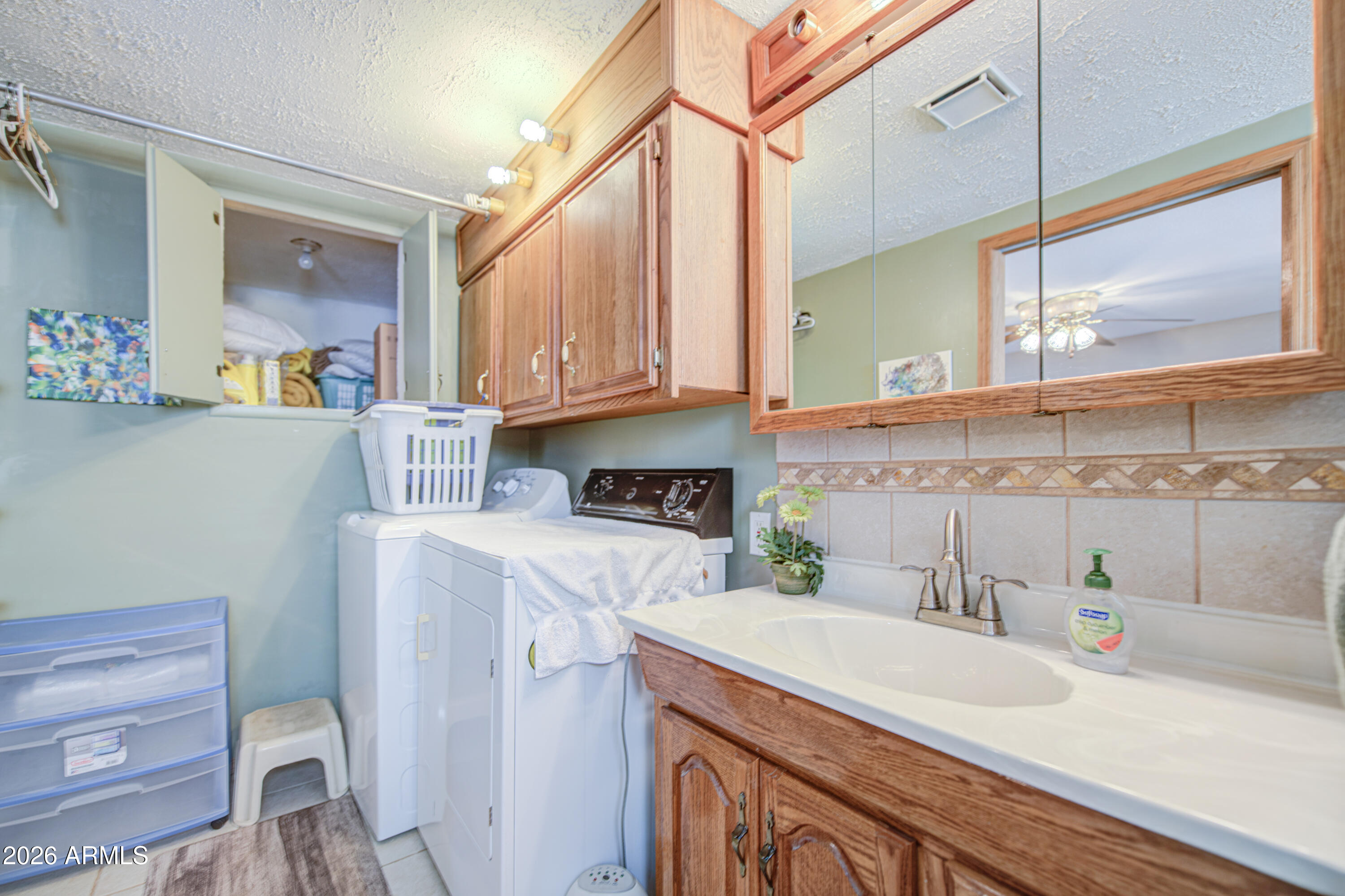111 South Greenfield Road, Unit 765 Mesa, AZ 85206 - Photo 26 of 31 a kitchen with stainless steel appliances granite countertop a sink a stove and a wooden cabinets