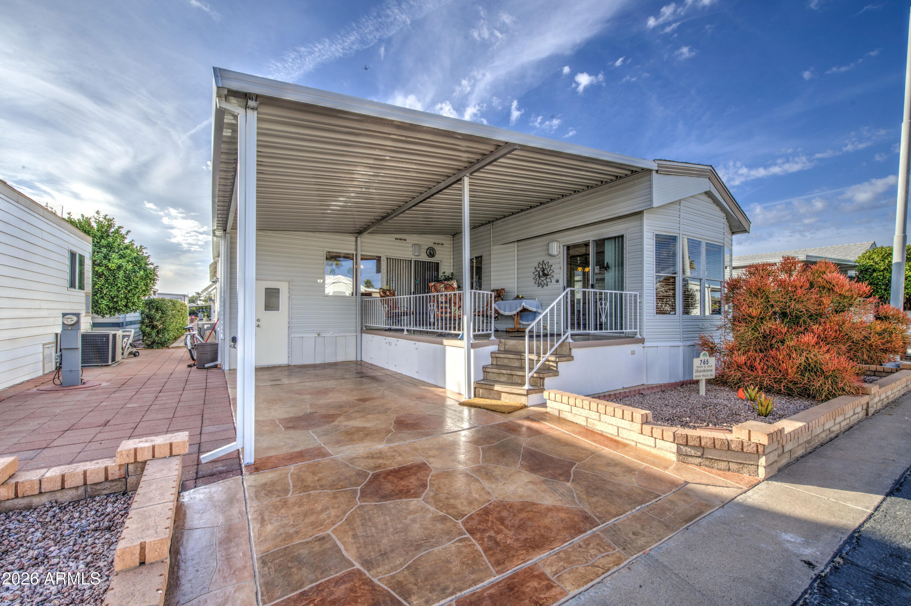 111 South Greenfield Road, Unit 765 Mesa, AZ 85206 - Photo 4 of 31 a view of a patio with table and chairs with wooden floor and plants