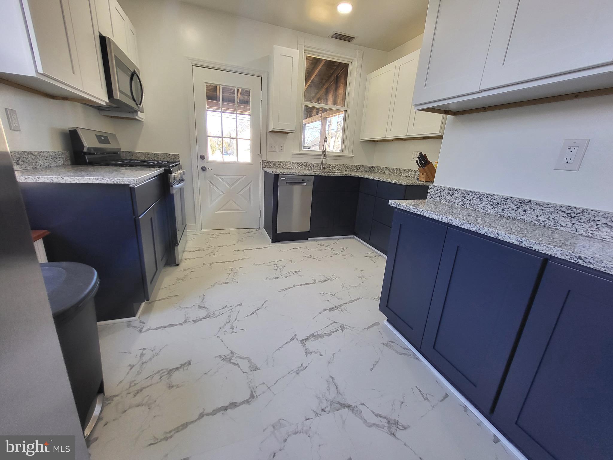3108 Texas Avenue Baltimore, MD 21234 - Photo 16 of 34 a kitchen with stainless steel appliances granite countertop a sink stove and cabinets