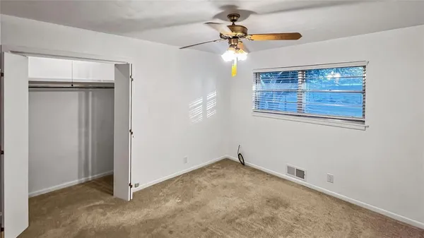 a view of an empty room with a fan