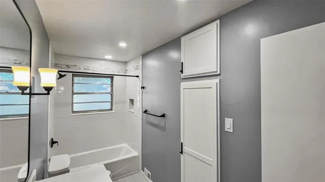 a bathroom with a shower and a glass door