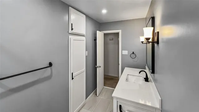 a bathroom with a sink and mirror
