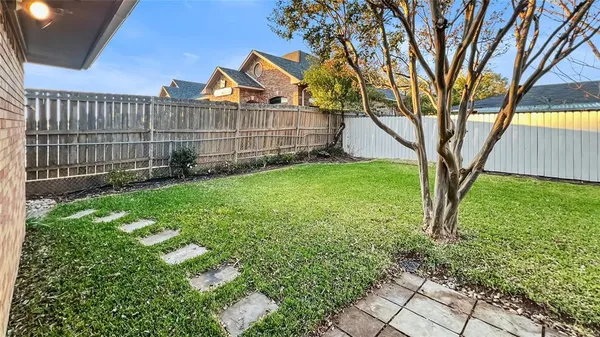 a view of a backyard with a large tree