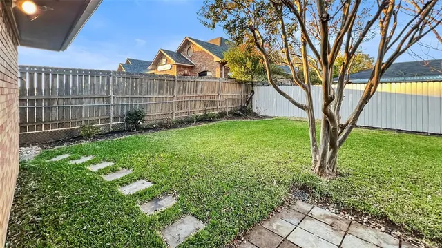 a view of a backyard with a large tree