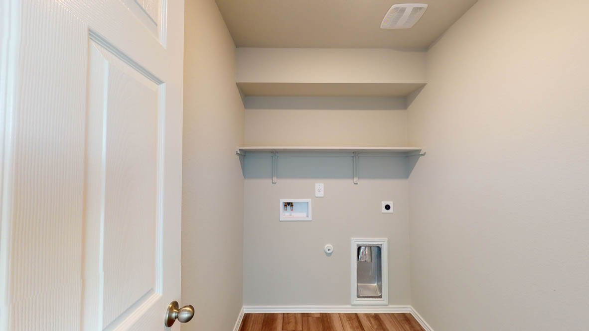 509 Hector Loop Georgetown, TX 78626 - Photo 28 of 31 A dedicated utility space with shelving and connections for laundry appliances, offering practical storage solutions.