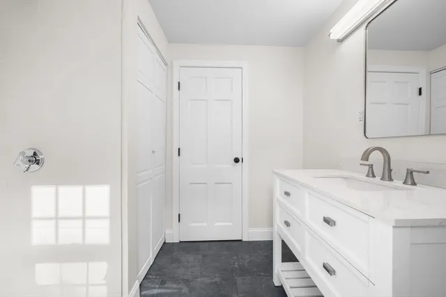 a view of a bathroom with two sinks and a mirror