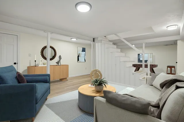 a living room with furniture and a mirror