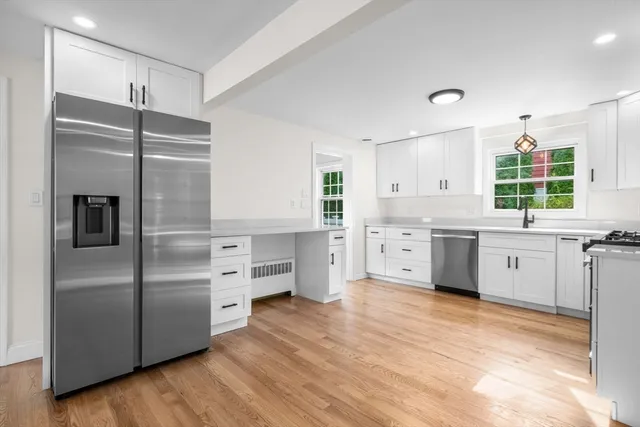 a kitchen with stainless steel appliances a refrigerator sink and cabinets