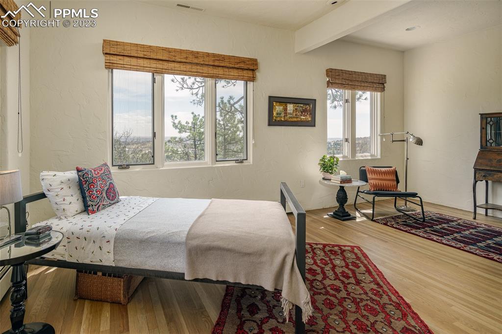 52 Marland Road Colorado Springs, CO 80906 - Photo 23 of 48 a bedroom with a bed and wooden floor