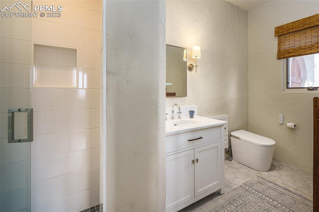 52 Marland Road Colorado Springs, CO 80906 - Photo 25 of 48 a bathroom with a toilet sink and mirror