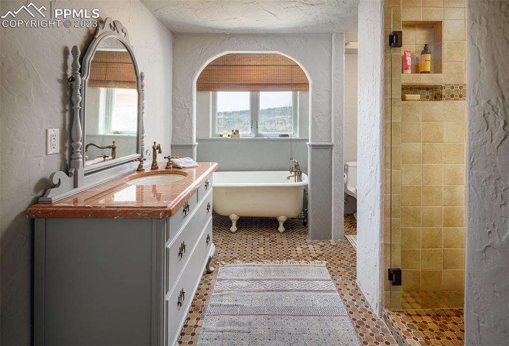 52 Marland Road Colorado Springs, CO 80906 - Photo 28 of 48 a bathroom with a double vanity sink and a mirror