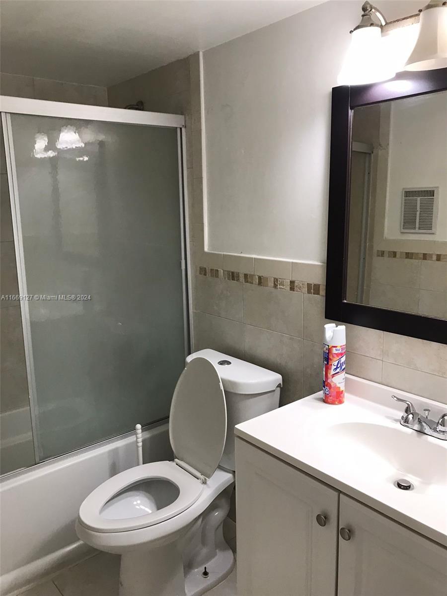 423 Northeast 210th Cir Terrace, Unit 10425 Miami, FL 33179 - Photo 17 of 37 a bathroom with a sink a toilet and shower