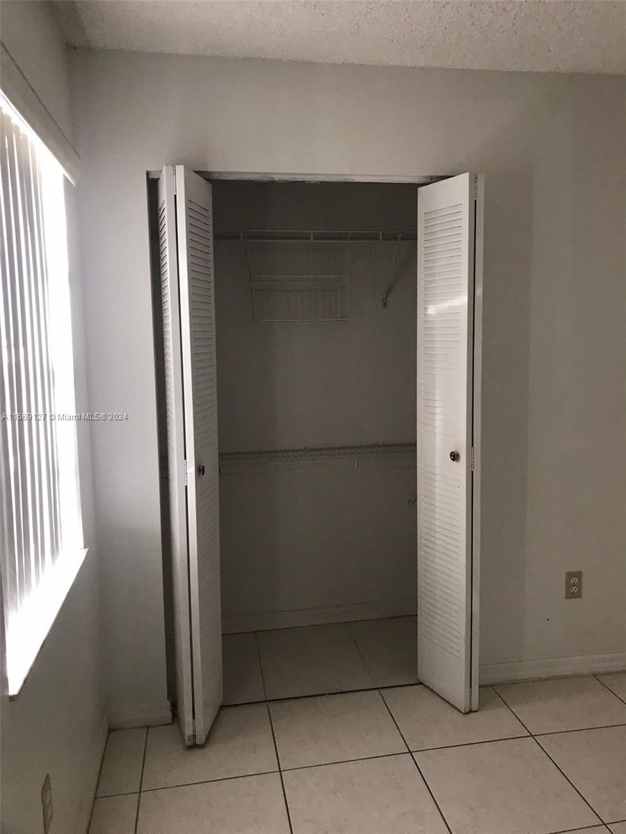 423 Northeast 210th Cir Terrace, Unit 10425 Miami, FL 33179 - Photo 25 of 37 an empty room with windows