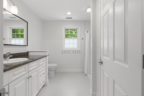3 Wing Road Wilmington, MA 01887 - Photo 26 of 36 a bathroom with a granite countertop sink a toilet a and mirror