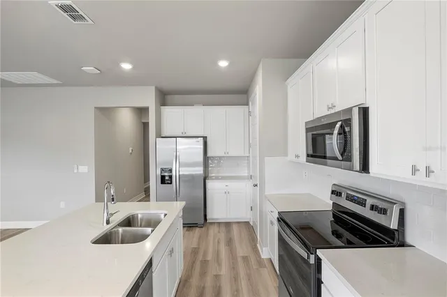 a kitchen with refrigerator and stove