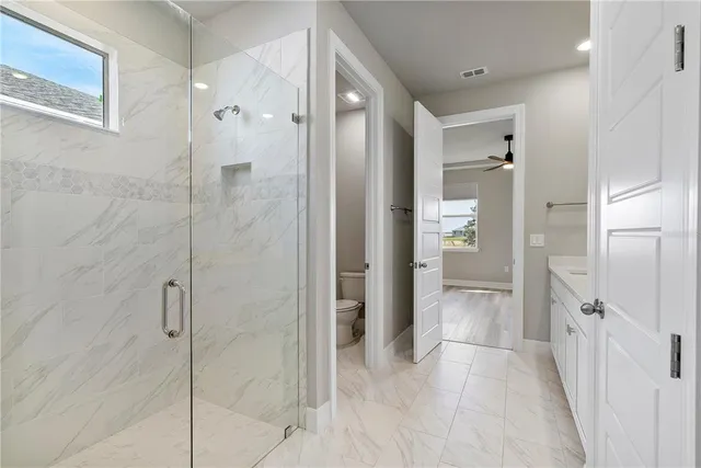 a bathroom with a shower and a sink