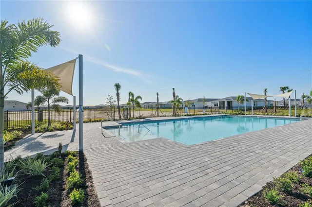 a view of a swimming pool with outdoor seating