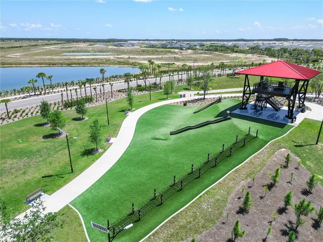 a view of a swimming pool with lawn chairs under an umbrella