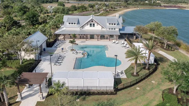 an aerial view of a swimming pool and lake view