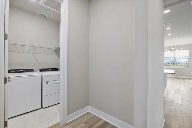 a view of storage and utility room with washer and dryer