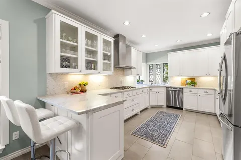a kitchen with a sink cabinets and wooden floor