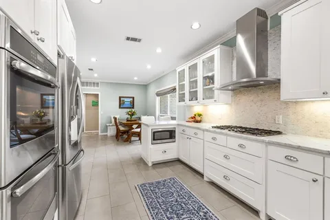 a kitchen with stainless steel appliances granite countertop a stove and a sink
