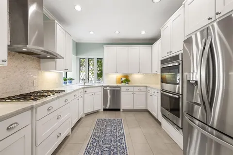a kitchen with granite countertop stainless steel appliances and counter space