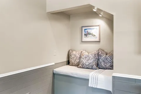 a white couch sitting next to a white wall