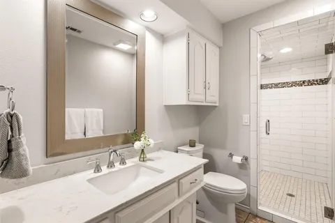 a bathroom with a sink toilet and shower