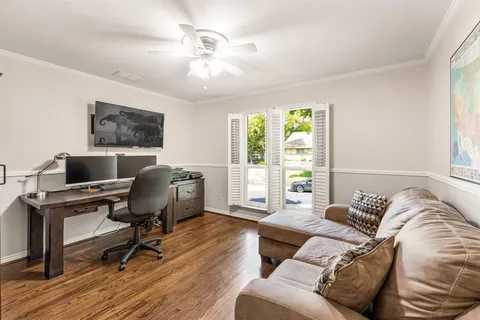 a view of a livingroom with workspace and a window