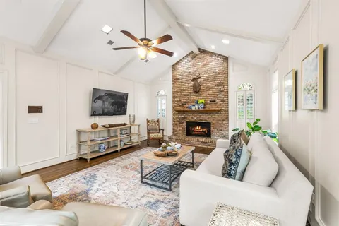 a living room with furniture fireplace and a flat screen tv