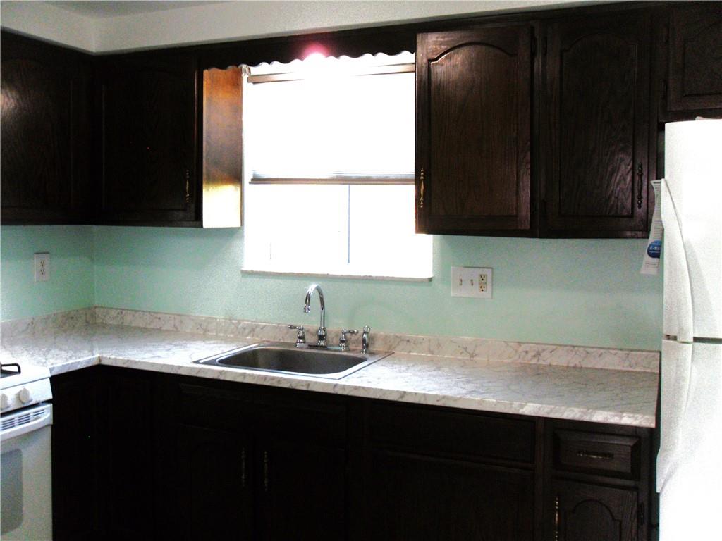 419 Streets Run Road Pittsburgh, PA 15236 - Photo 5 of 46 a kitchen with a sink a window and cabinets