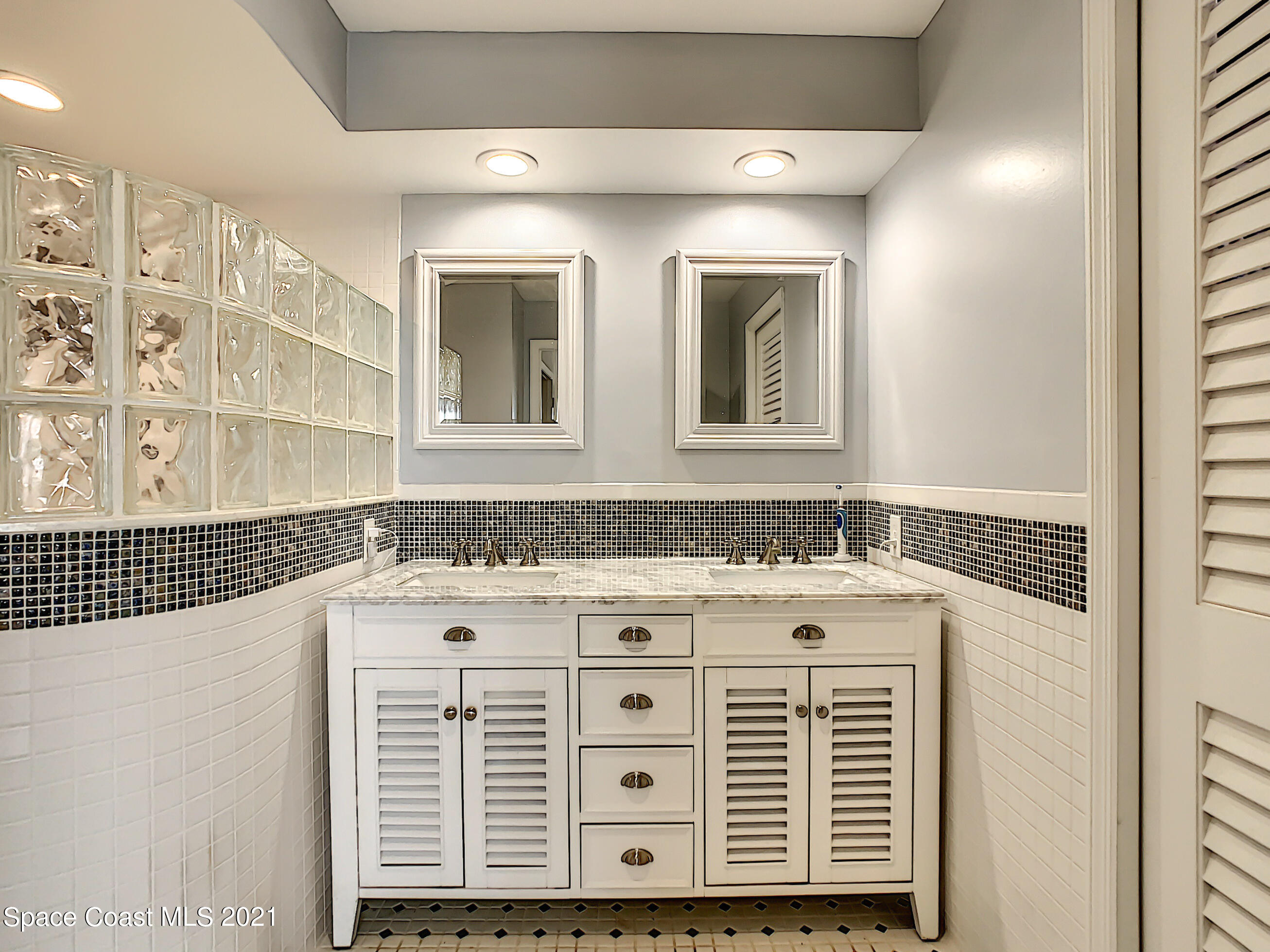 738 Nassau Road Cocoa Beach, FL 32931 - Photo 16 of 26 a bathroom with a sink and a mirror