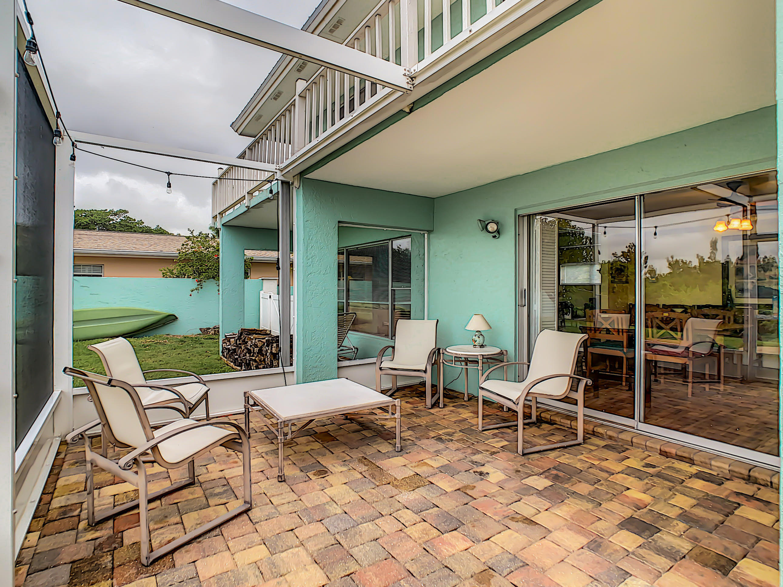 738 Nassau Road Cocoa Beach, FL 32931 - Photo 21 of 26 a view of a patio with a dining table and chairs