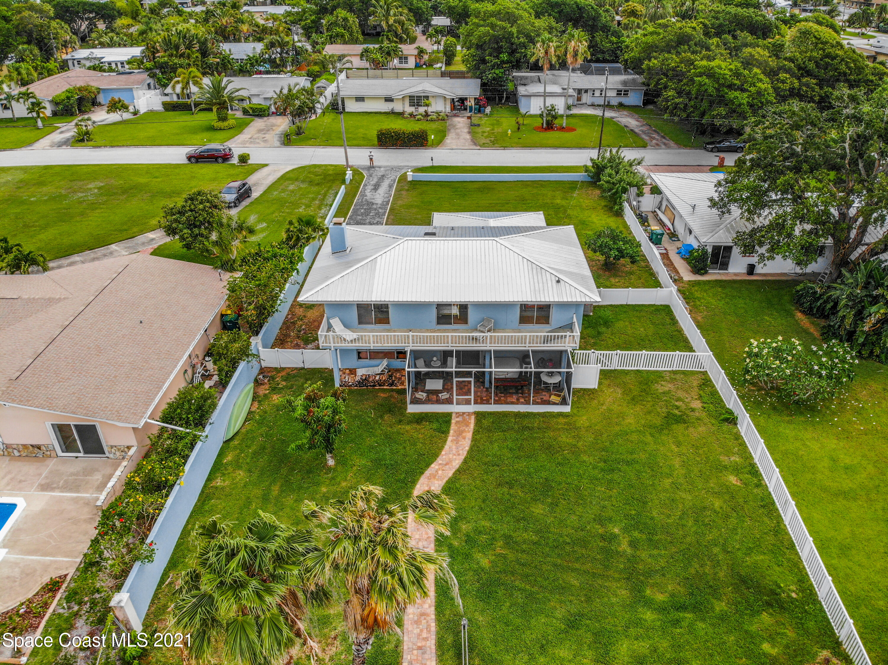 738 Nassau Road Cocoa Beach, FL 32931 - Photo 24 of 26 an aerial view of a house with swimming pool big yard and large trees