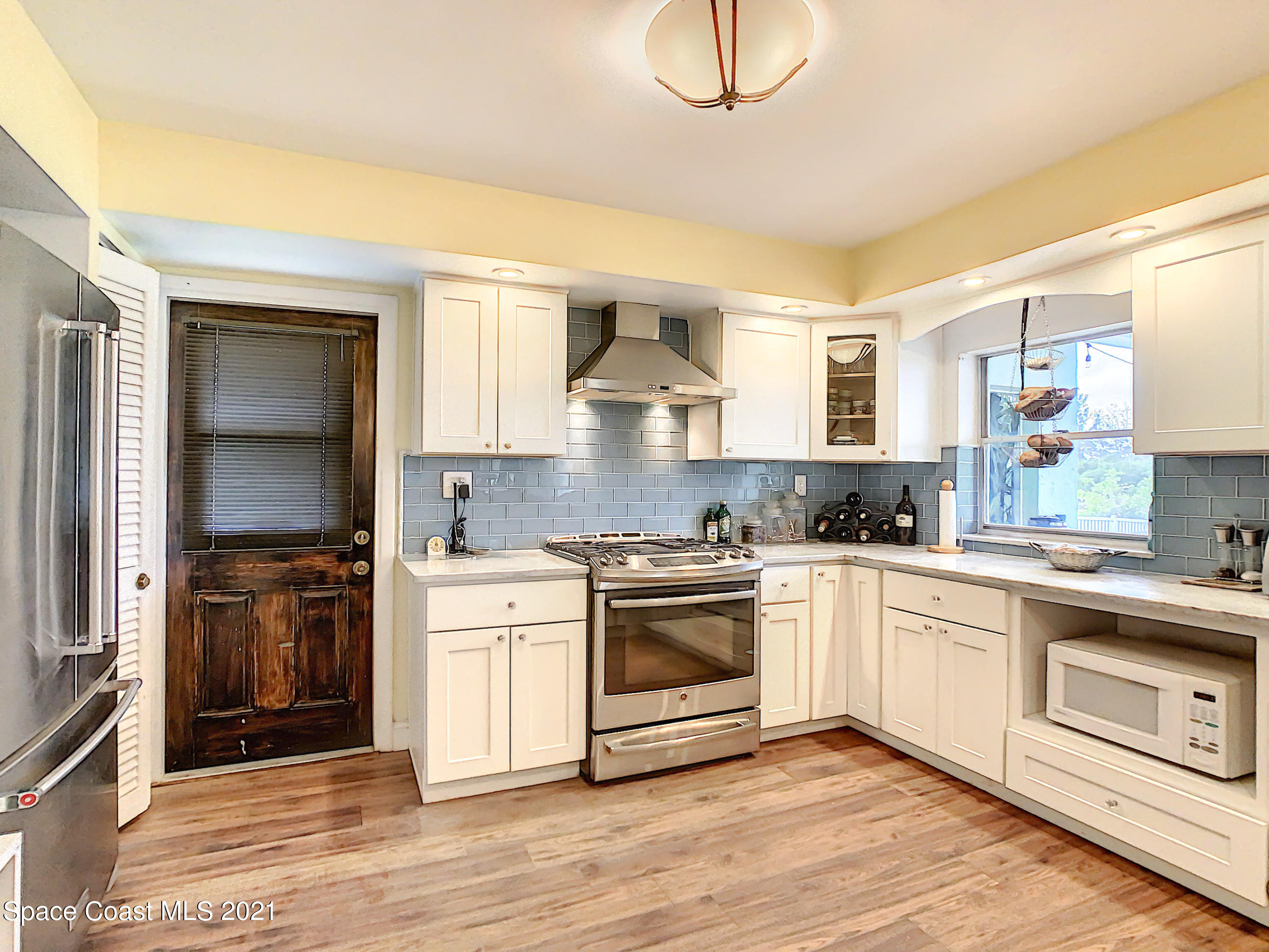 738 Nassau Road Cocoa Beach, FL 32931 - Photo 10 of 26 a kitchen with a stove a sink and a refrigerator