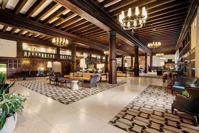 a living room with lots of furniture and kitchen view