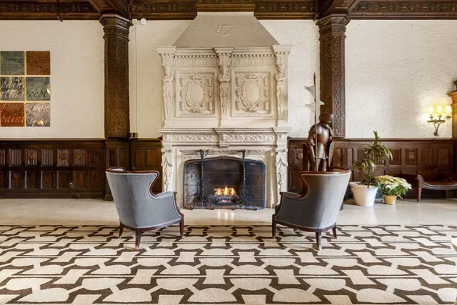 a living room with furniture a fireplace and a table