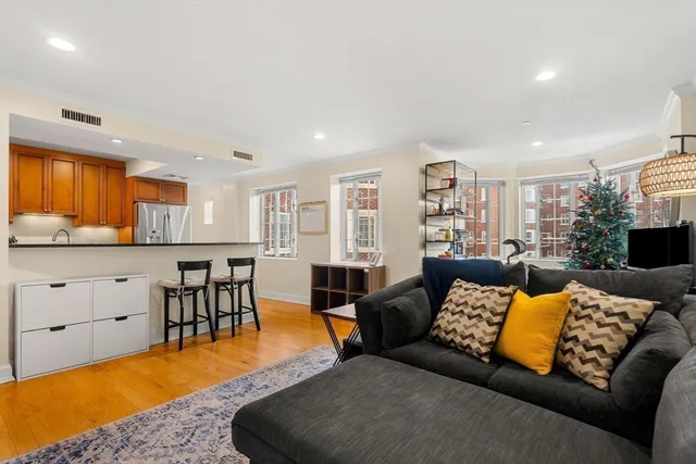 a living room with furniture and kitchen view