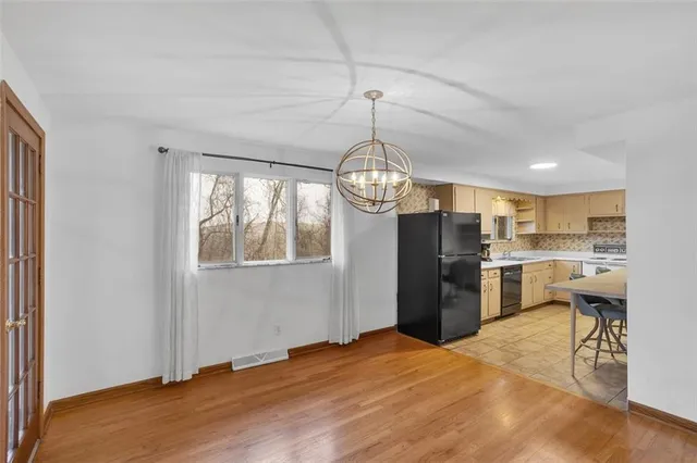 a view of a kitchen and refrigerator