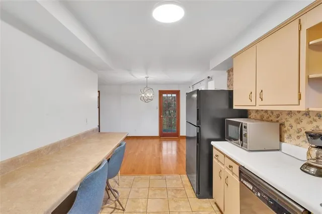 a kitchen with a sink a refrigerator and cabinets