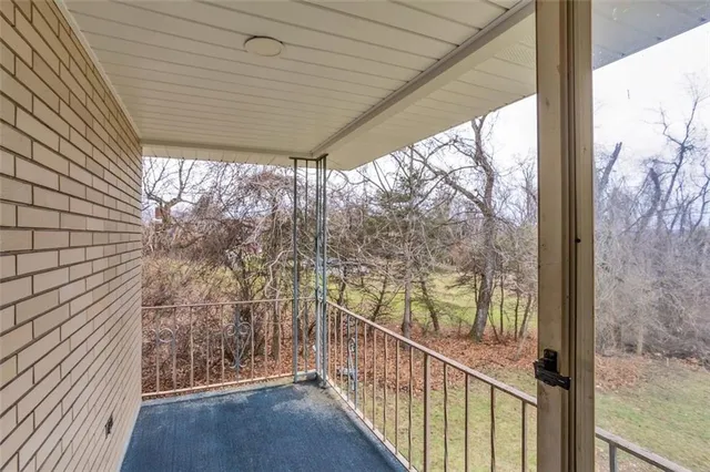 a view of a room with wooden floor and stairs
