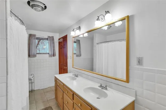 a bathroom with a sink vanity and mirror
