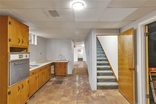 a kitchen with granite countertop a refrigerator and cabinets