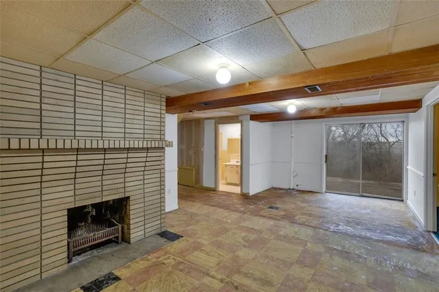 a view of an empty room with a fireplace